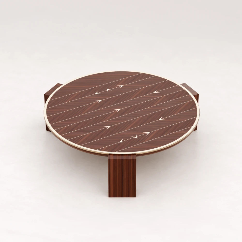 CT01 Coffee Table from the X Collection by Eva Szumilas in reddish wood, with a round top, pale rim, arrow inlays and three block legs.
